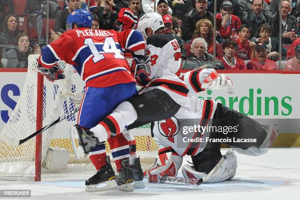 Tomas Plekanec of Montreal Canadiens takes a shot on goalie Martin Brodeur of New Jersey Devils in front of Bryce Salvador of New Jersey Devils...