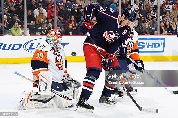 Umberger of the Columbus Blue Jackets redirects a shot into the chest of goaltender Dwayne Roloson of the New York Islanders during the second period...