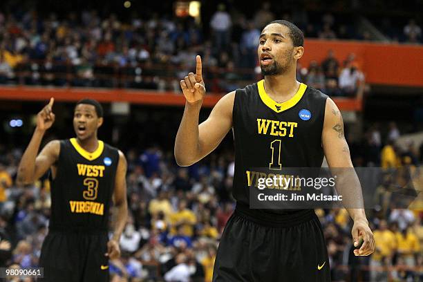 Da'Sean Butler and Devin Ebanks of the West Virginia Mountaineers react in the second half against the Kentucky Wildcats during the east regional...