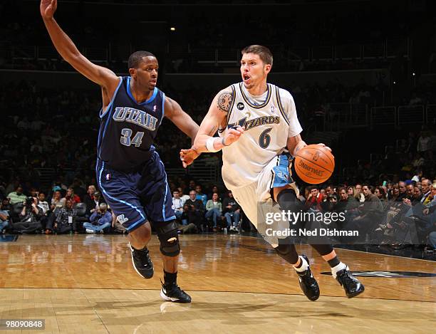 Mike Miller of the Washington Wizards drives against C.J. Miles of the Utah Jazz at the Verizon Center on March 27, 2010 in Washington, DC. NOTE TO...