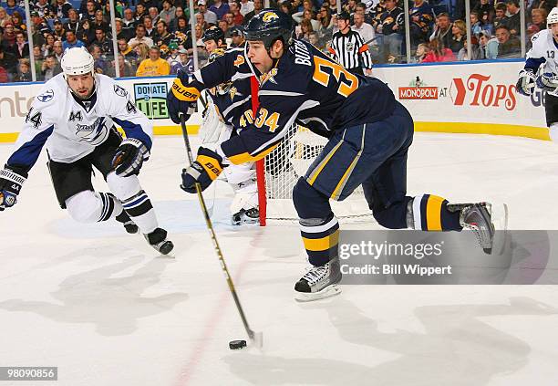 Chris Butler of the Buffalo Sabres makes a long pass out of the Sabres zone in front of Nate Thompson of the Tampa Bay Lightning on March 27, 2010 at...