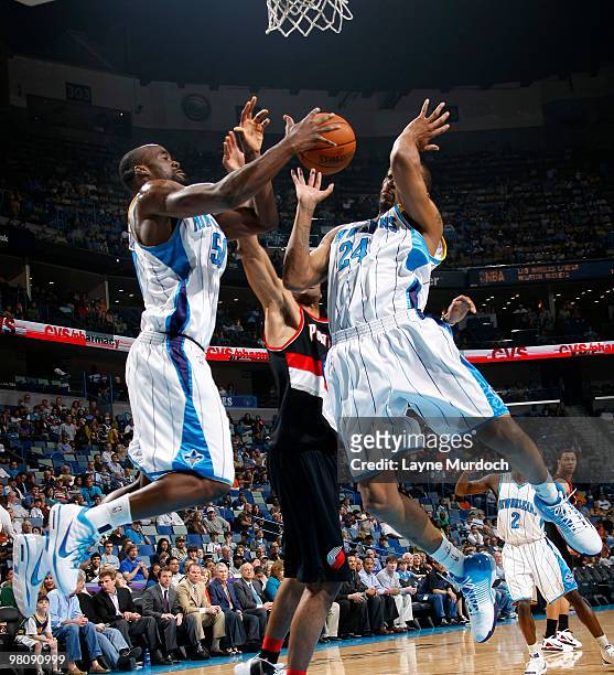 Emeka Okafor and Morris Peterson of the New Orleans Hornets go for a rebound against the Portland Trail Blazers on March 27, 2010 at the New Orleans...