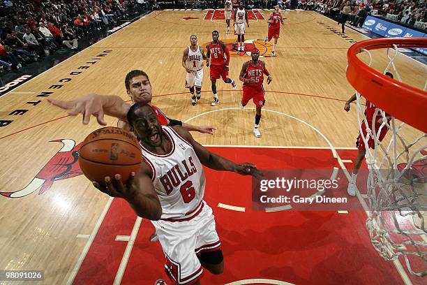 Ronald Murray of the Chicago Bulls shoots a layup against Brook Lopez of the New Jersey Nets on March 27, 2010 at the United Center in Chicago,...