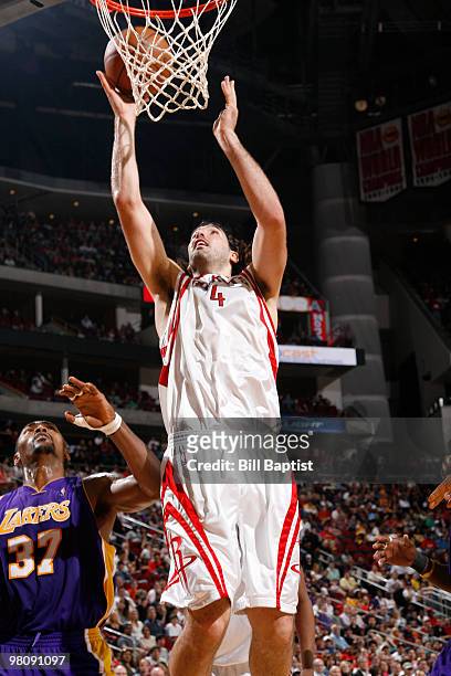 Luis Scola of the Houston Rockets shoots the ball over Ron Artest of the Los Angeles Lakers on March 27, 2010 at the Toyota Center in Houston, Texas....