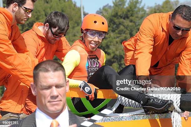 Speed skater Apolo Ohno and actor/wrestler John Cena onstage during a pre-filmed segment for Nickelodeon's 23rd Annual Kids' Choice Awards held at...