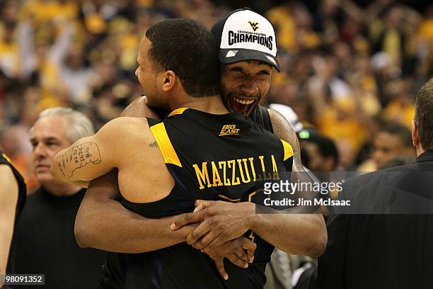 Da'Sean Butler and Joe Mazzulla of the West Virginia Mountaineers celebrate after they won 73-66 against the Kentucky Wildcats during the east...