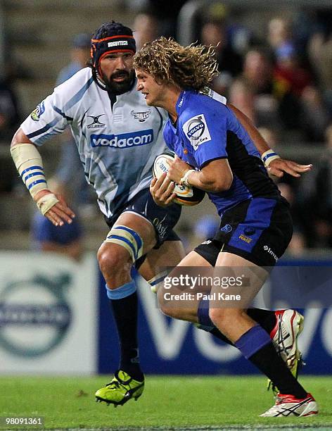 Nick Cummins of the Force looks for a break past Victor Matfield of the Bulls during the round seven Super 14 match between the Western Force and the...