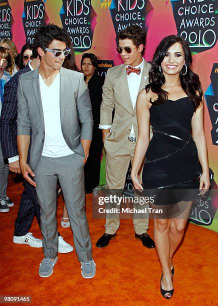 Joe Jonas, Nick Jonas of The Jonas Brothers and actress Demi Lovato arrive at Nickelodeon's 23rd Annual Kids' Choice Awards at Pauley Pavilion on...