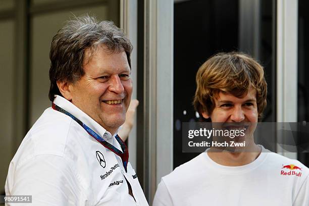 Mercedes Benz Vice President of Motorsport Norbert Haug is seen with Sebastian Vettel of Germany and Red Bull Racing before practice for the...