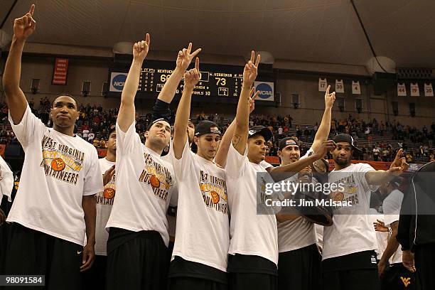 The West Virginia Mountaineers celebrate with the East Regional trophy after West Virginia won 73-66 against the Kentucky Wildcats during the east...