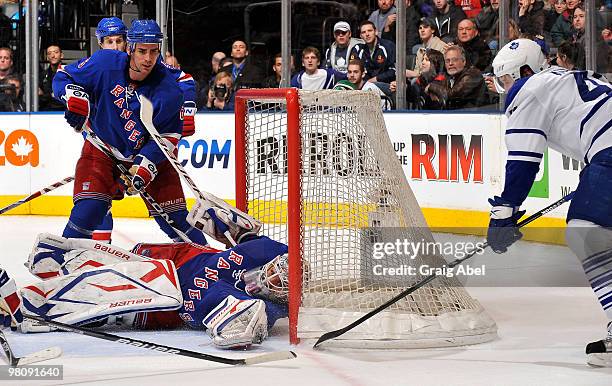 Nikolai Kulemin of the Toronto Maple Leafs scores the overtime game-winning goal on Henrik Lundqvist of the New York Rangers with Wade Redden on the...