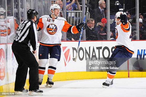 Josh Bailey celebrates his game winning goal with teammate Dylan Reese, both of the New York Islanders, during the overtime period against the...