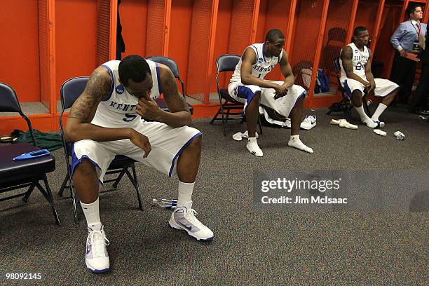 Ramon Harris, Darius Miller and Eric Bledsoe of the Kentucky Wildcats sit in the locker room dejected after they lost 73-66 against the West Virginia...