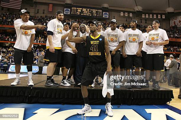 John Flowers of the West Virginia Mountaineers celebrates with his teammates after West Virginia won 73-66 against the Kentucky Wildcats during the...