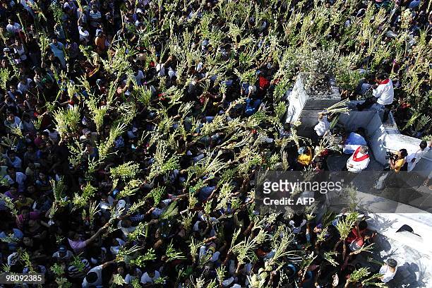 Sea of Filipino Roman Catholics wave palm leaves at a church in Bulacan, north of Manila on March 28, 2010. The Palm Sunday marks the start of the...