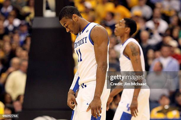 John Wall of the Kentucky Wildcats walks on the court with his head down against the West Virginia Mountaineers during the east regional final of the...