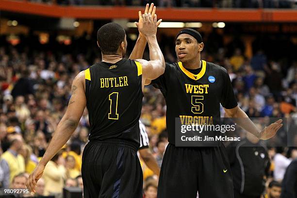 Kevin Jones and Da'Sean Butler of the West Virginia Mountaineers celebrate a play in the second half against the Kentucky Wildcats during the east...