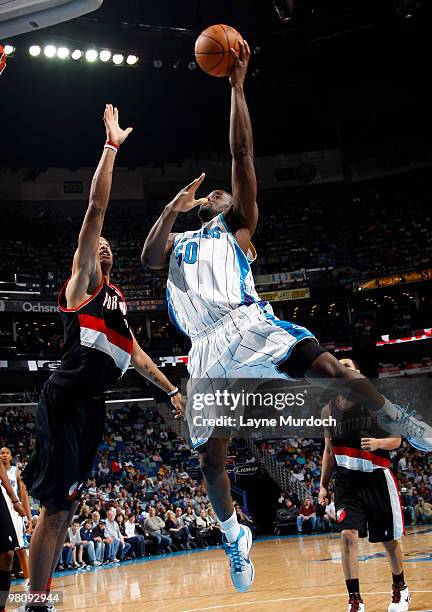 Emeka Okafor of the New Orleans Hornets shoots over Marcus Camby of the Portland Trail Blazers on March 27, 2010 at the New Orleans Arena in New...