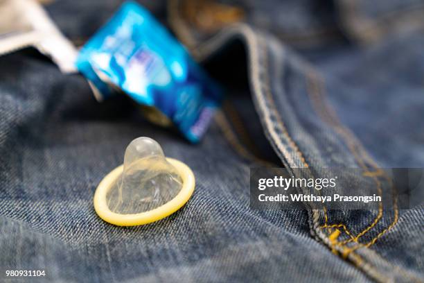 condoms in package in jeans. - condoom stockfoto's en -beelden