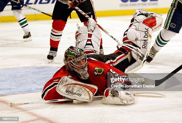 Cristobal Huet of the Chicago Blackhawks hits the ice as he looks for the puck against the Vancouver Canucks at the United Center on March 5, 2010 in...