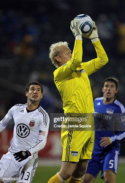 Goalkeeper Jimmy Neilsen of the Kansas City Wizards makes a save as Wizards defender Matt Besler and Chris Pontius of D.C United look on during the...