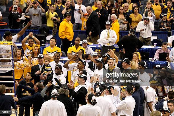 Da'Sean Butler of the West Virginia Mountaineers celebrates after he cut down the net following West Virginia's 73-66 win against the Kentucky...