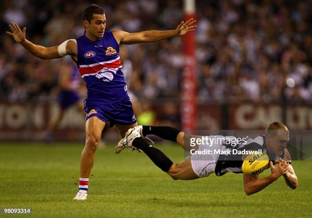 Josh Hill of the Bulldogs is outmarked by Tarkyn Lockyer of the Magpies during the round one AFL match between the Western Bulldogs and the...