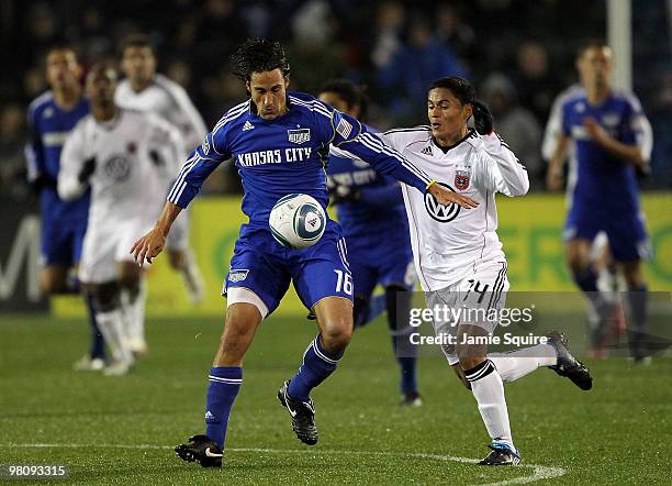 Josh Wolff of the Kansas City Wizards battles Andy Najar of D.C United for the ball during the game on March 27, 2010 at Community America Park in...