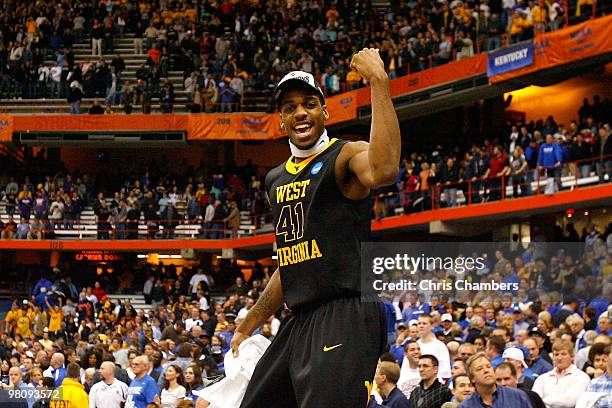 John Flowers of the West Virginia Mountaineers celebrates on the scorer's table after West Virginia won 73-66 against the Kentucky Wildcats during...