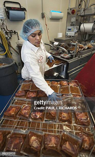 Cuisine Solutions worker Wendy stacks a beef product on March 23, 2010 in Alexandria, Virginia, during the food packing process. Cusine Solutions...