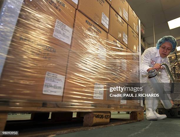 Worker in the production line at Cuisine Solutions wraps up a pallet of Salmon with Lemon Herb Sauce on March 23 in Alexandria, Virginia. Cusine...