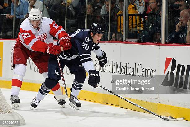 Ryan Suter of the Nashville Predators skates against Brad Stuart of the Detroit Red Wings on March 27, 2010 at the Bridgestone Arena in Nashville,...