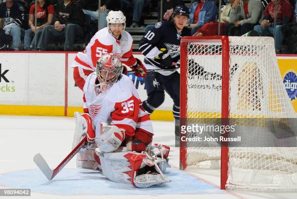 Jimmy Howard of the Detroit Red Wings blocks a shot against Martin Erat of the Nashville Predators on March 27, 2010 at the Bridgestone Arena in...