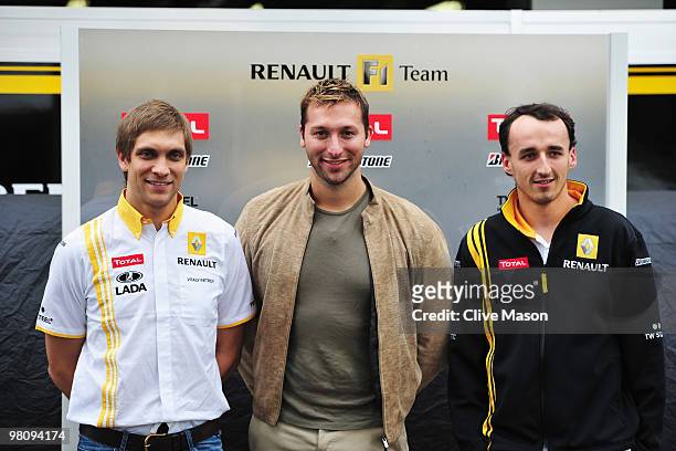 Ian Thorpe is seen with Renault drivers Vitaly Petrov of Russia and Robert Kubica of Poland in the Renault garage before the Australian Formula One...