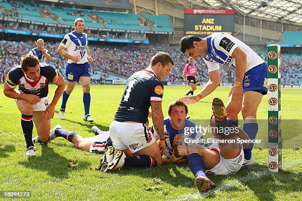 Josh Morris of the Bulldogs scores a try during the round three NRL match between the Canterbury Bulldogs and the Sydney Roosters at ANZ Stadium on...