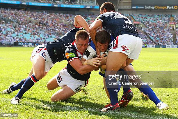 Josh Morris of the Bulldogs scores a try during the round three NRL match between the Canterbury Bulldogs and the Sydney Roosters at ANZ Stadium on...