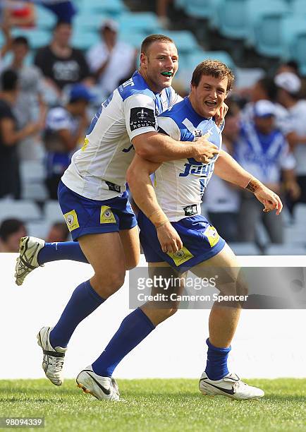 Blake Green of the Bulldogs congratulates team mate Josh Morris after scoring a try during the round three NRL match between the Canterbury Bulldogs...
