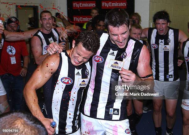 Luke Ball and Darren Jolly of the Magpies sing the team song for the first time after winning the round one AFL match between the Western Bulldogs...