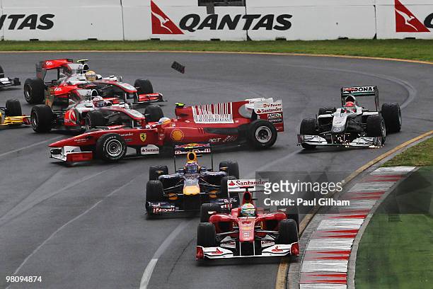 Michael Schumacher of Germany and Mercedes GP takes avoiding action as Fernando Alonso of Spain and Ferrari spins at the first corner at the start of...
