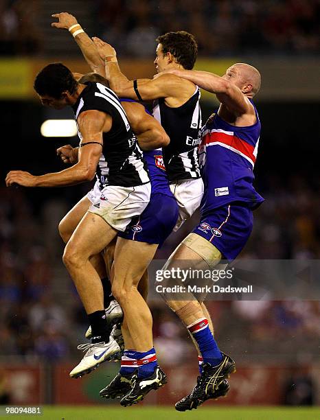 Barry Hall of the Bulldogs competes with Scott Pendlebury and Luke Ball of the Magpies during the round one AFL match between the Western Bulldogs...