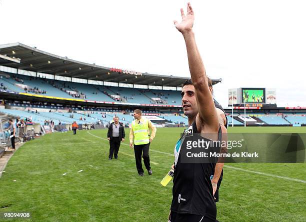 Captain Domenic Cassisi of the Power waves to the crowd after winning the round one AFL match between the Port Adelaide Power and the North Melbourne...