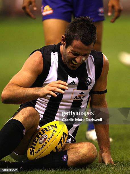 Alan Didak of the Magpies struggles to get up after crashing heavily to the ground during the round one AFL match between the Western Bulldogs and...