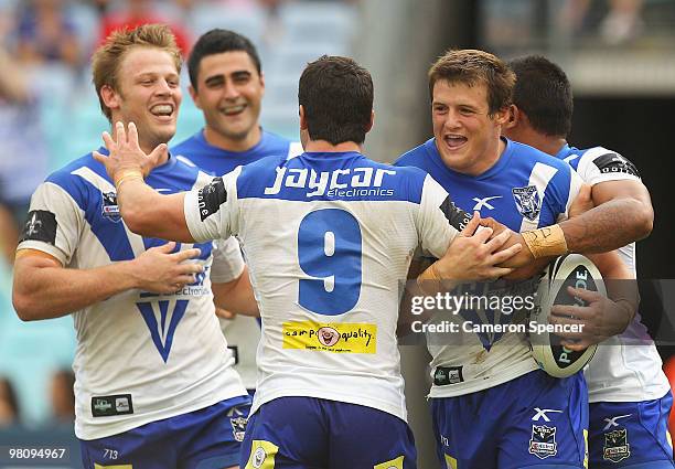 Josh Morris of the Bulldogs celebrates scoring a try with team mates during the round three NRL match between the Canterbury Bulldogs and the Sydney...