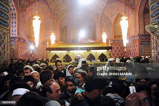 In this photo taken on March 20 Afghan men visit the Hazrat-i Ali shrine in Mazar-i-Sharif, the centre of Afghan New Year's or Nowruz celebrations....