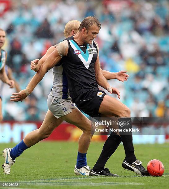 Dean Brogan of the Power kicks the ball during the round one AFL match between the Port Adelaide Power and the North Melbourne Kangaroos at AAMI...