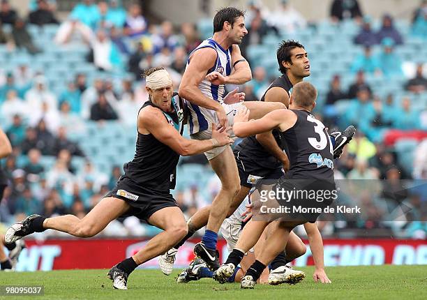 Jay Schulz of the Power tackles Brady Rawlings of the Kangaroos during the round one AFL match between the Port Adelaide Power and the North...
