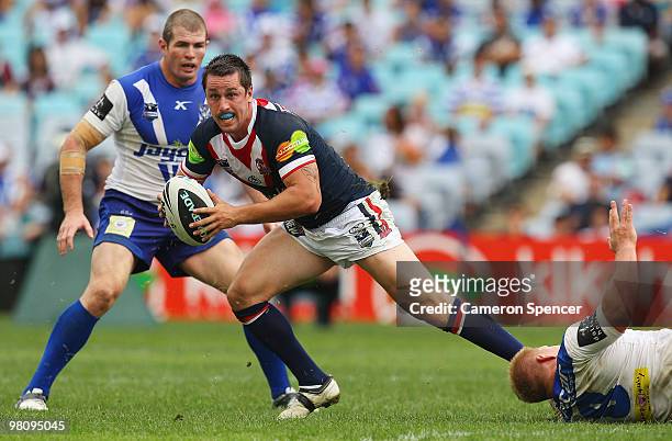 Mitchell Pearce of the Roosters is tackled during the round three NRL match between the Canterbury Bulldogs and the Sydney Roosters at ANZ Stadium on...