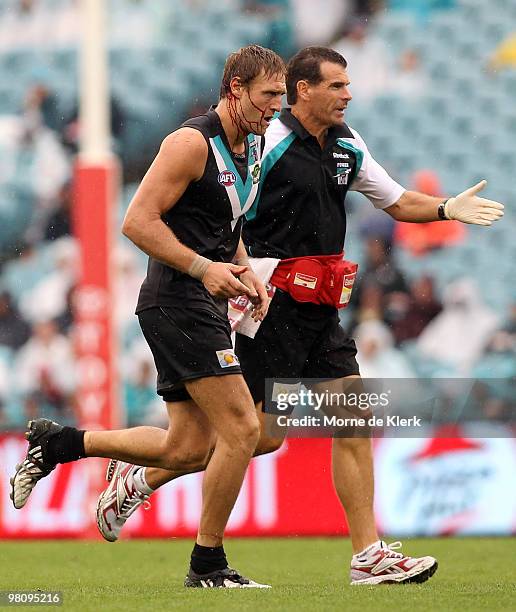 Jay Schultz of the Power comes off the field with a blood head injury during the round one AFL match between the Port Adelaide Power and the North...