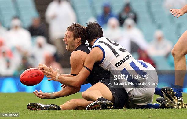 Jay Schultz of the Power is tackled by Sam Wright of the Kangaroos during the round one AFL match between the Port Adelaide Power and the North...