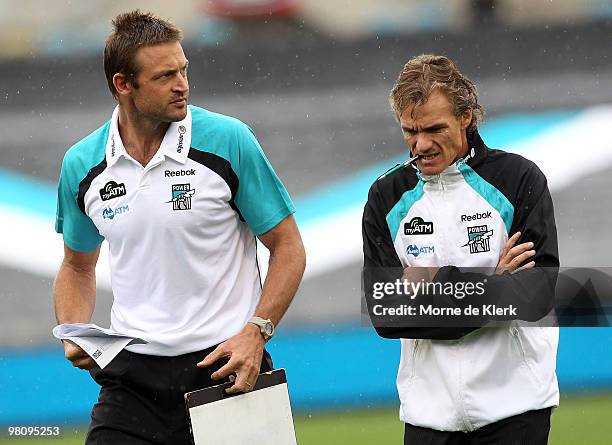 Matthew Primus and Dean Laidley of the Power leave the field after the three quarter time break during the round one AFL match between the Port...